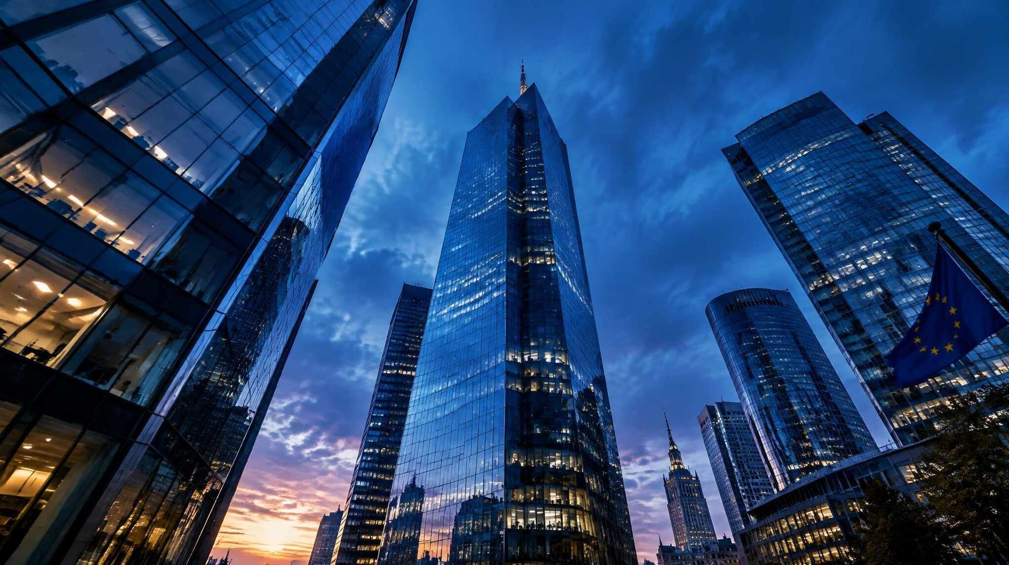 Glass office buildings seen from below at dusk
